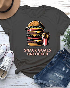 Unisex t-shirt with “Snack Goals Unlocked” text in gamer-style design by Memez Store
