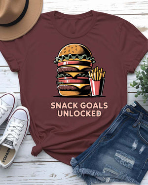 Unisex t-shirt with “Snack Goals Unlocked” text in gamer-style design by Memez Store