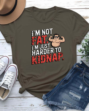 Unisex t-shirt with bold black typography that reads “I Am Not Fat I Am Just Harder to Kidnap” – meme fashion with a body-positive punchline.