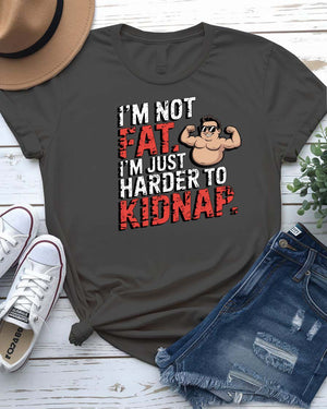 Unisex t-shirt with bold black typography that reads “I Am Not Fat I Am Just Harder to Kidnap” – meme fashion with a body-positive punchline.
