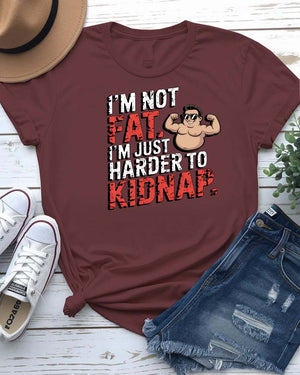 Unisex t-shirt with bold black typography that reads “I Am Not Fat I Am Just Harder to Kidnap” – meme fashion with a body-positive punchline.