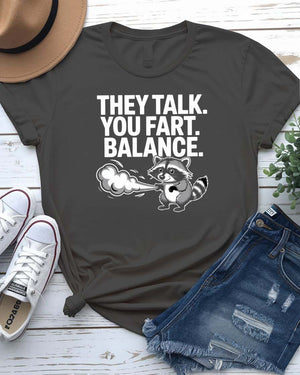 Unisex tee with the bold phrase “They Talked You Fart” in playful, modern type – a perfect shirt for awkward humor lovers.