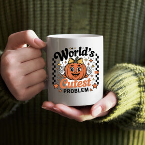 World's Cuttest Problem Halloween Meme Mug on desk with coffee