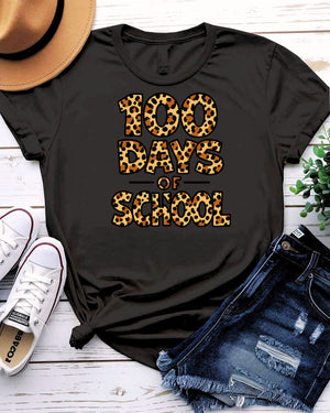 Kids 100 Days of School t-shirt in green camo with bright orange text