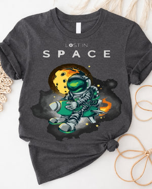 Space graphic t-shirt with astronaut floating through galaxy design front view
