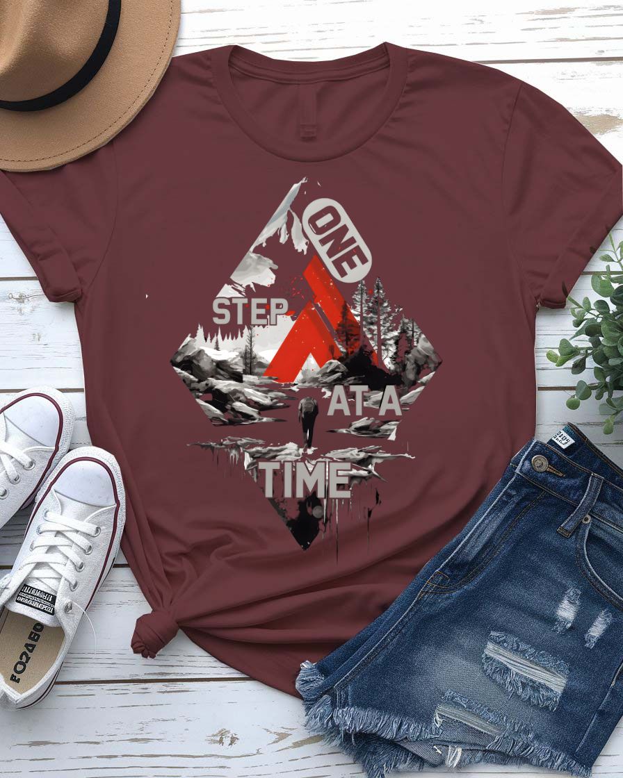 One Step at a Time Adventure Tee with boot prints up mountain on model
