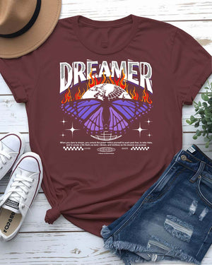 Dreamer Streetwear T-Shirt with silhouette and paper airplane graphic on model