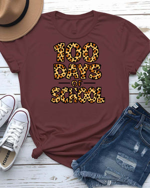 Kids 100 Days of School t-shirt in green camo with bright orange text