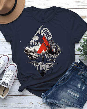 One Step at a Time Adventure Tee with boot prints up mountain on model