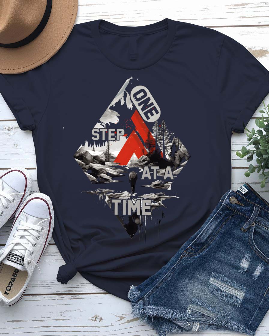 One Step at a Time Adventure Tee with boot prints up mountain on model