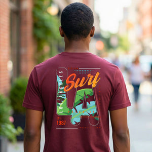 LA Surf Streetwear Tee with surfboard at sunset on model