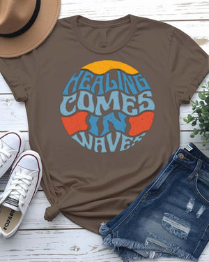 Healing Comes in Waves Tee with gentle ocean waves on model