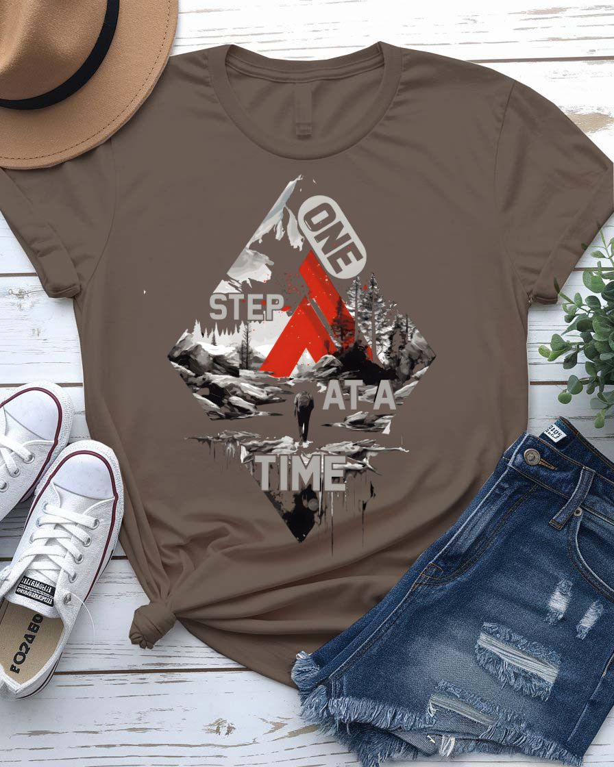 One Step at a Time Adventure Tee with boot prints up mountain on model