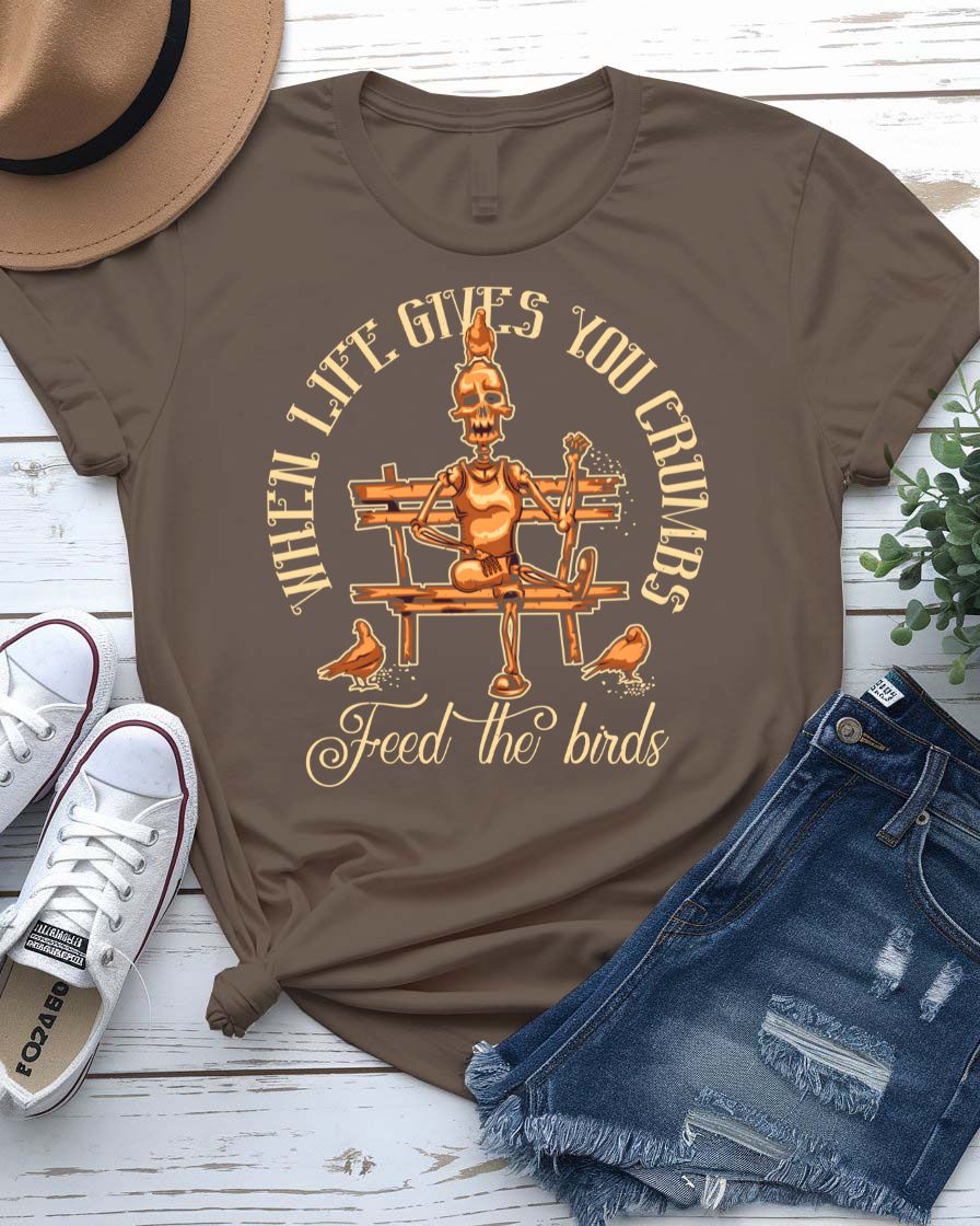 Feed The Bird T-Shirt with hand offering seeds to sparrow on model