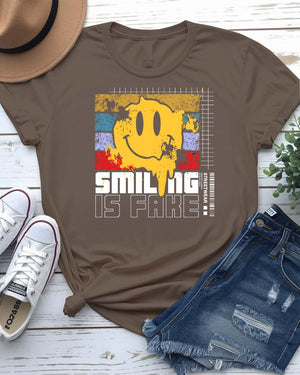 Smiling is Fake urban tee with cracked porcelain smile graphic on model