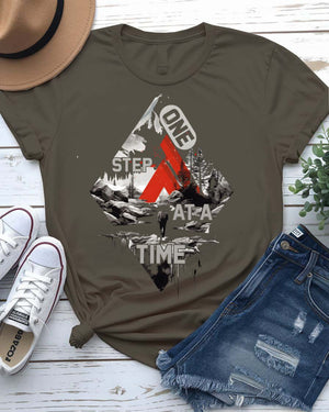One Step at a Time Adventure Tee with boot prints up mountain on model