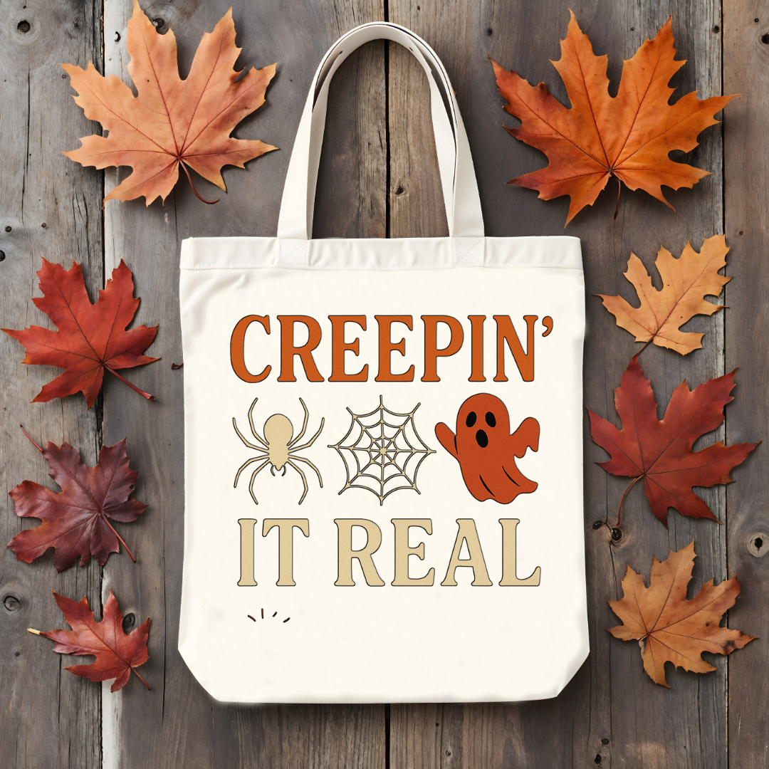 “Creepin’ It Real Halloween tote bag with ghost and spiderweb graphic”