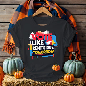 Front-facing Vote Like Rent’s Due Tomorrow tee on flat lay background