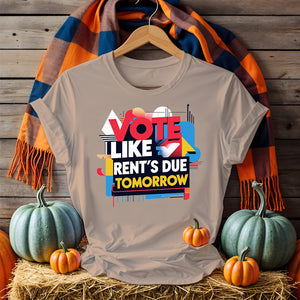 Front-facing Vote Like Rent’s Due Tomorrow tee on flat lay background
