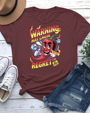 Funny t-shirt with “Warning May Cause Regret” meme quote printed in bold lettering, styled for food lovers and humor fans.
