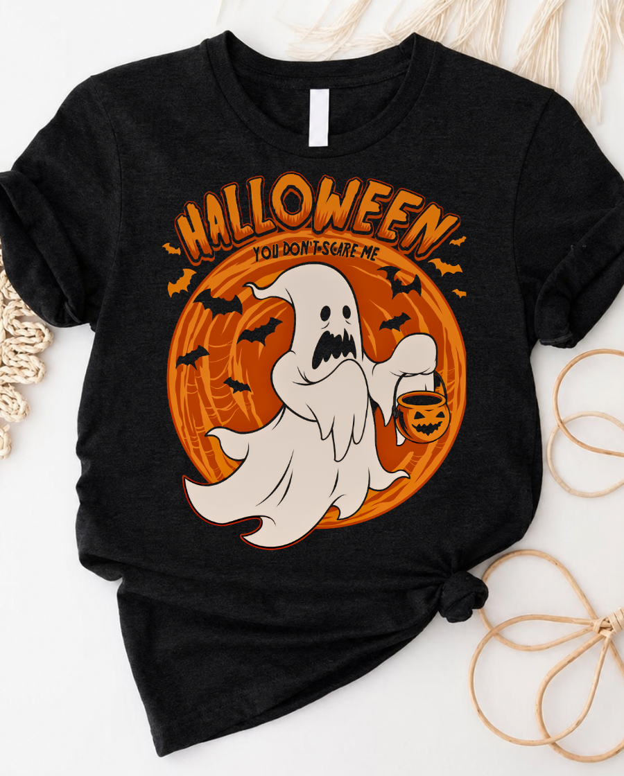 Halloween ghost tee with friendly ghost floating across pumpkin moon graphic