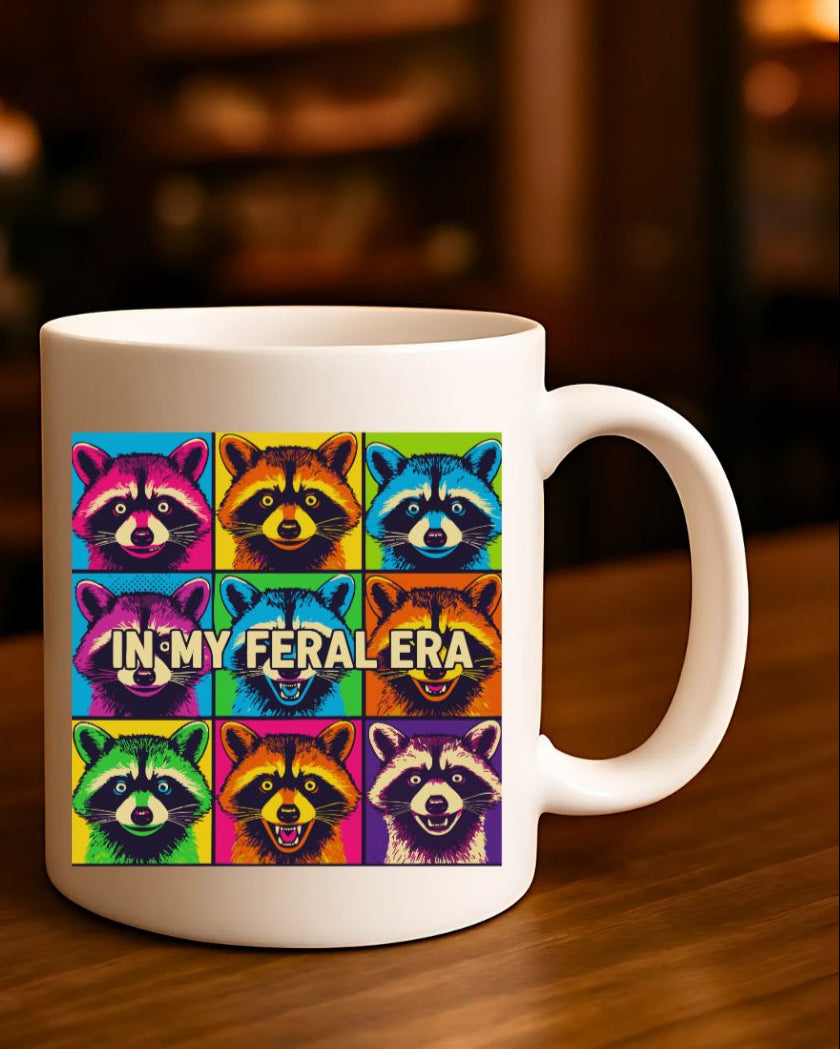 In My Feral Era Raccoon Mug – Funny ceramic coffee cup with chaotic raccoon meme design.