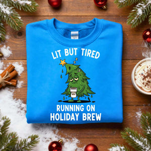 “Lit But Tired Christmas Sweatshirt – funny holiday meme sweatshirt for exhausted coffee lovers, cozy unisex fleece pullover from Memez.Store.