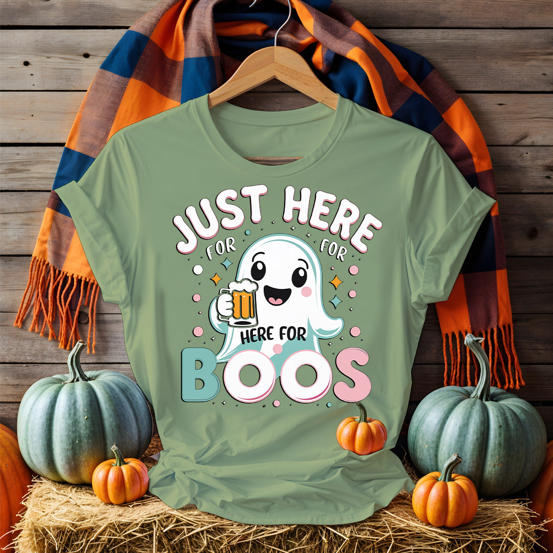 Model wearing “Just Here for the Boos” tee holding a drink at a Halloween party