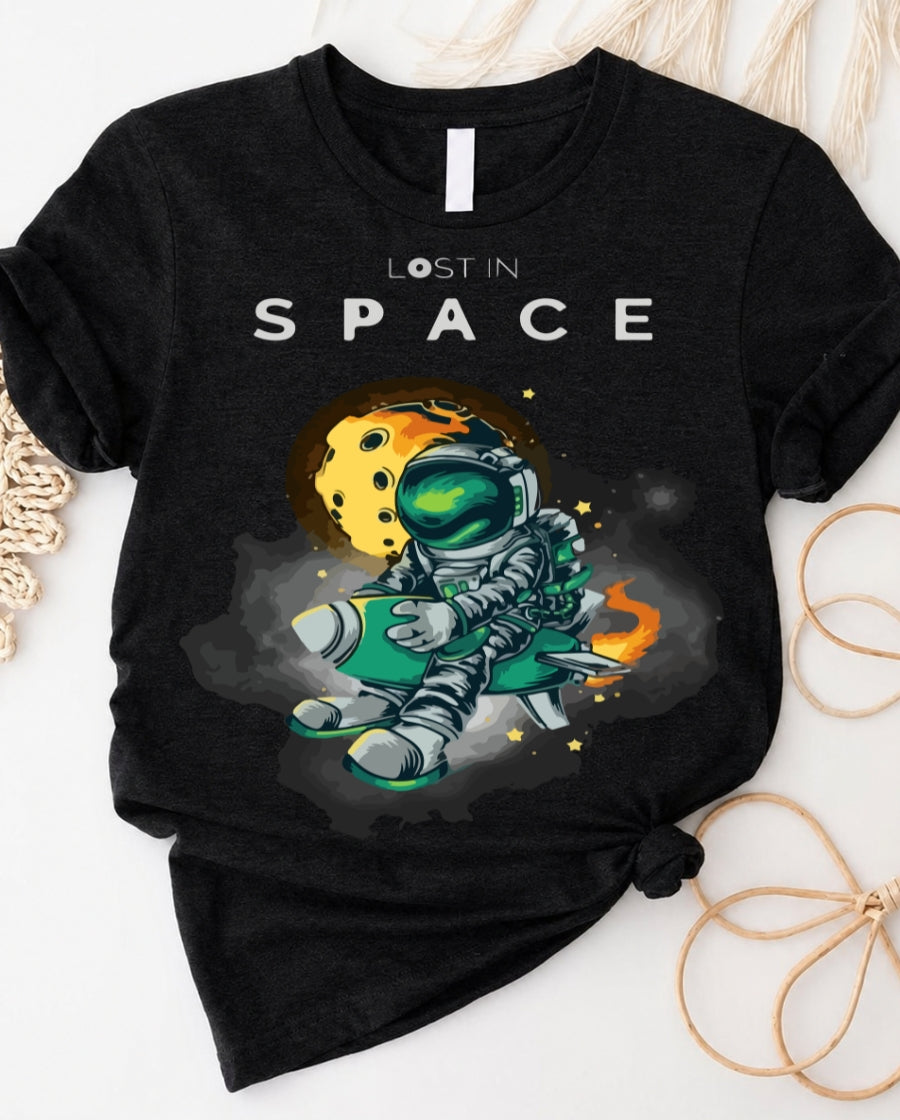 Space graphic t-shirt with astronaut floating through galaxy design front view