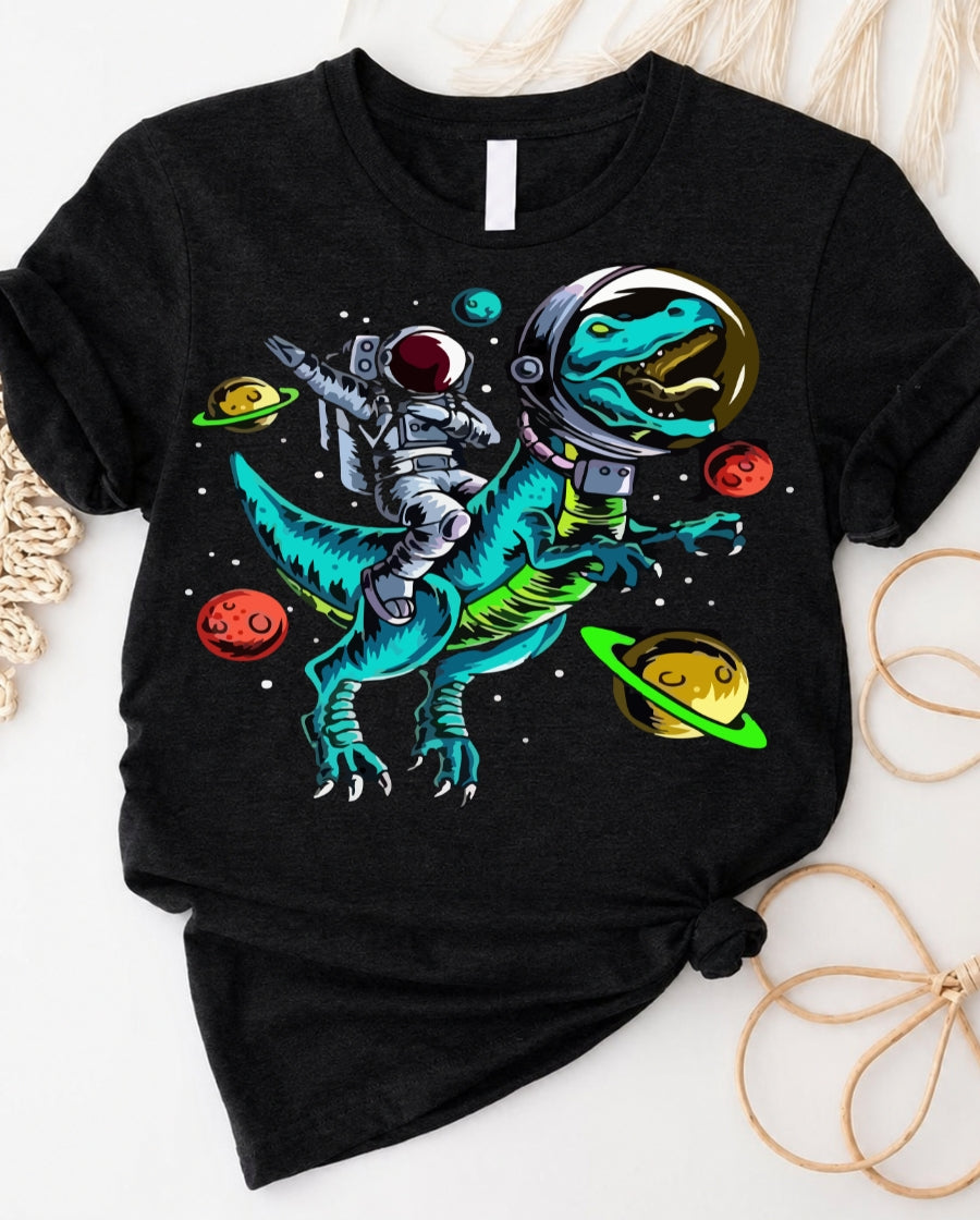 T-rex space ride t-shirt with astronaut riding dinosaur through galaxy